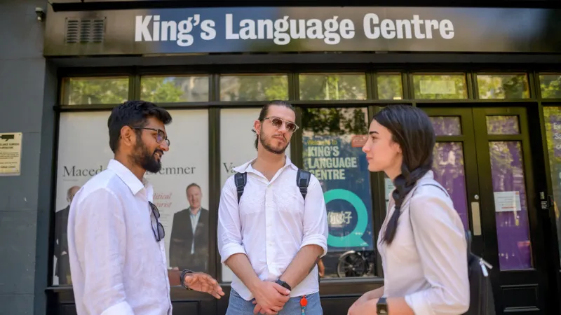Three students talking outside the Language Centre