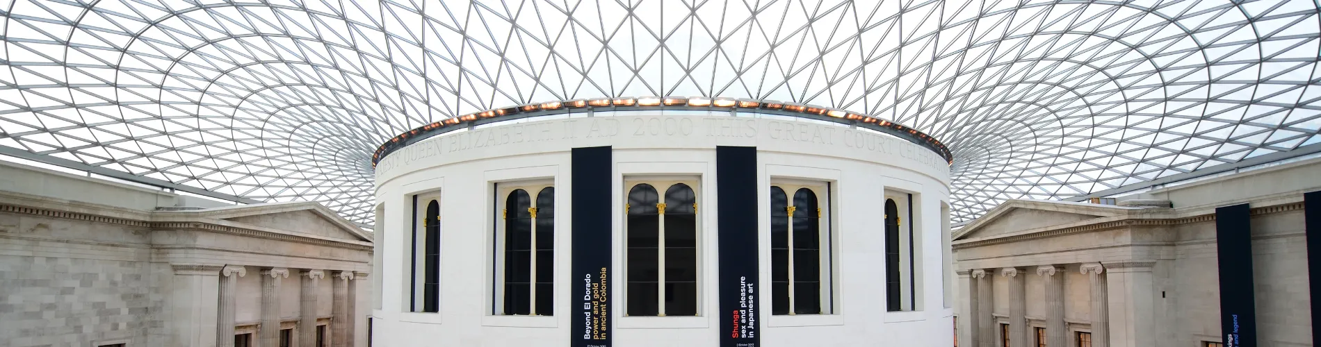 An image of the central hall of the british Museum, with the glass ceiling and staircase in the centre