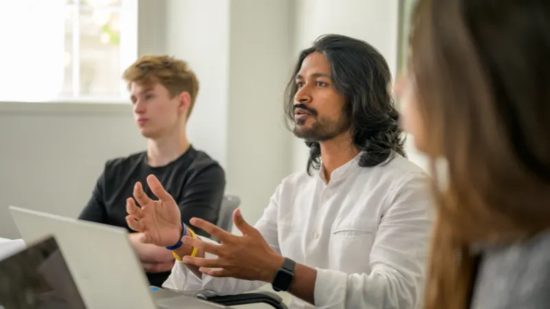 A student making a presentation inside a classroom.