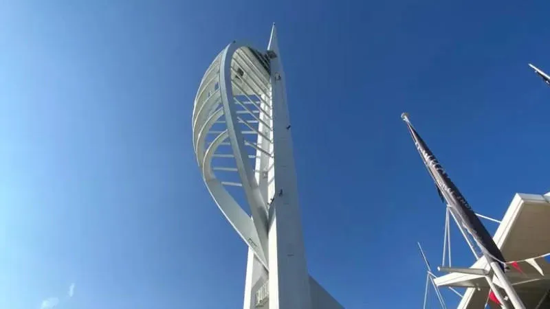 a large metal viewing tower in the shape of a ship's sail