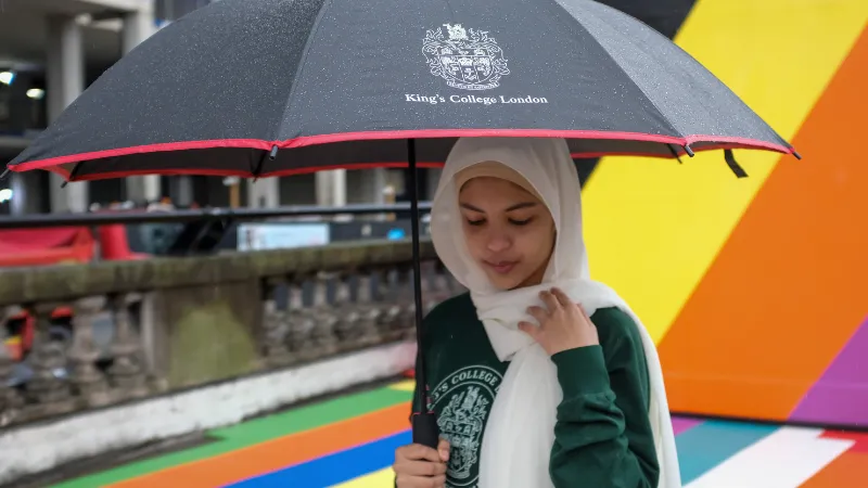 Student with umbrella in the rain
