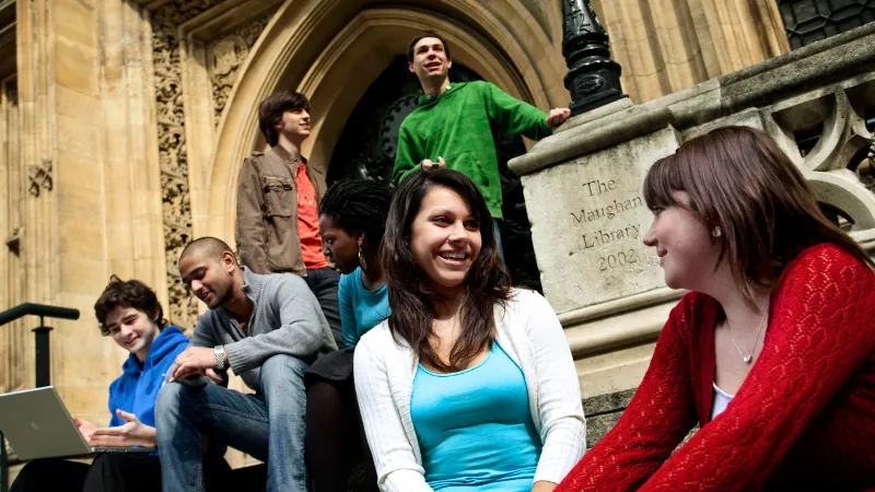 Students sat on Maughan Library steps chatting