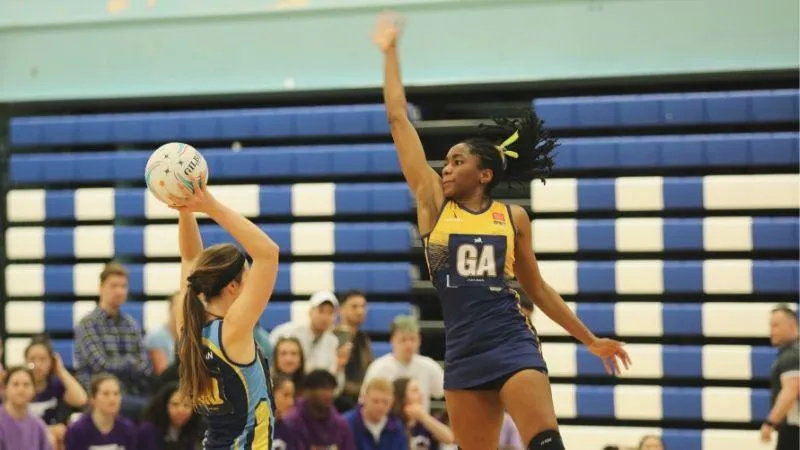A KCL Goal Attack netball player mid jump to block a pass