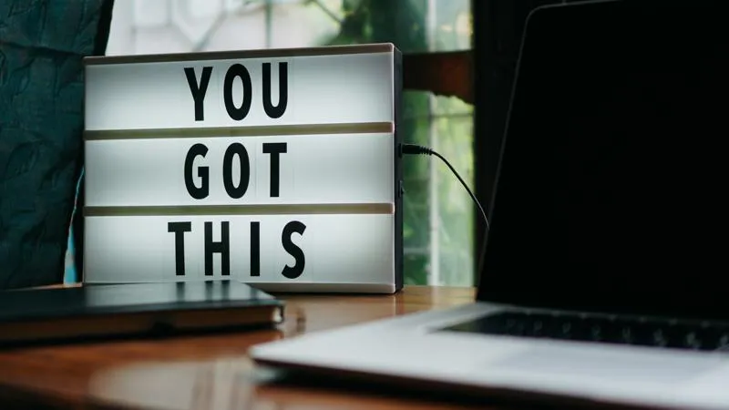 A lightbox with letters spelling out 'You Got This', next to a laptop