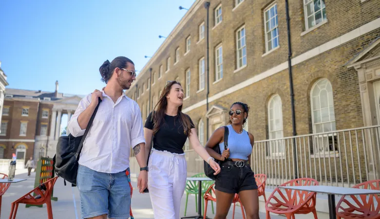 Three students walking across the quad at the King;s College London Strand Campus