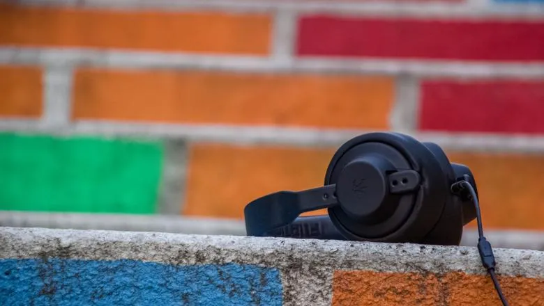 Music headphones in front of coloured bricks