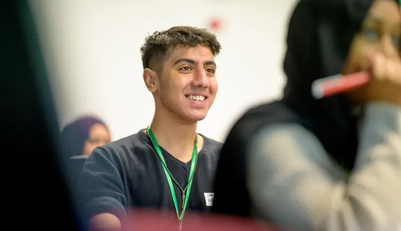 Student smiling during a class discussion.