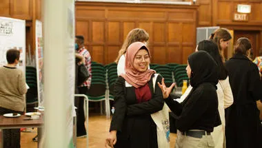 People chatting in an exhibition room.