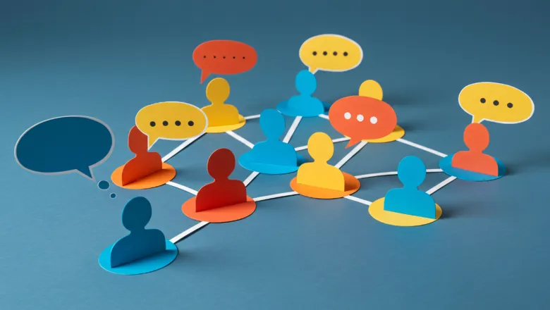 A series of connected paper silhouettes of people in yellow, red, and blue, with speech bubbles representing a dialogue between them