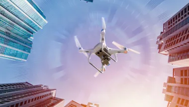Drone flying in between high-rise buildings
