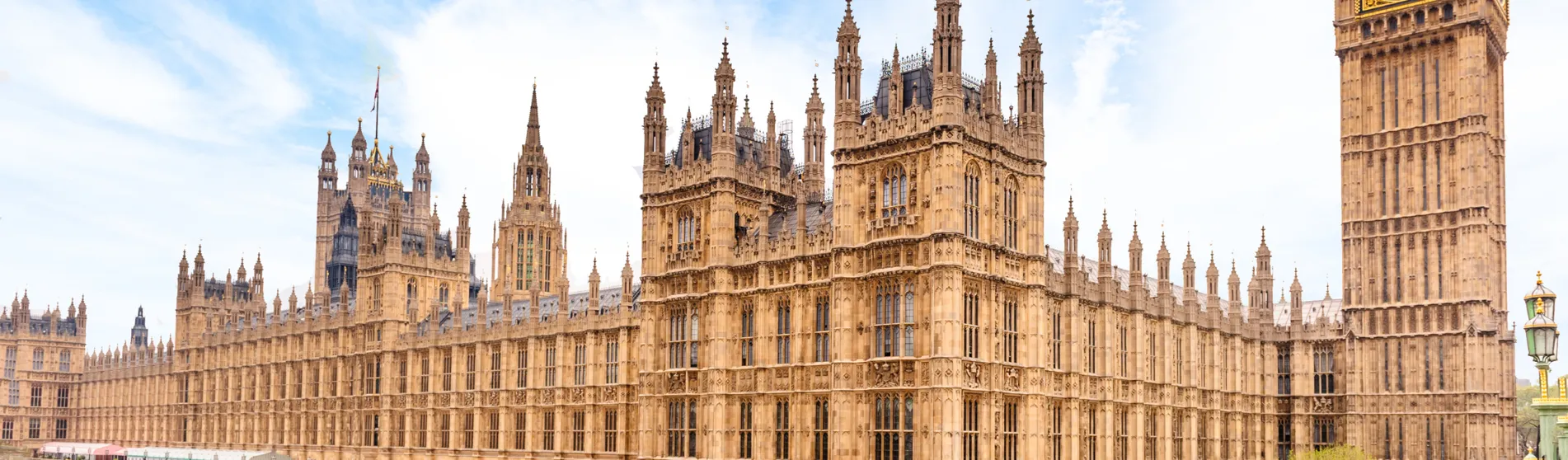 The Houses of Parliament against a blue, cloudy sky