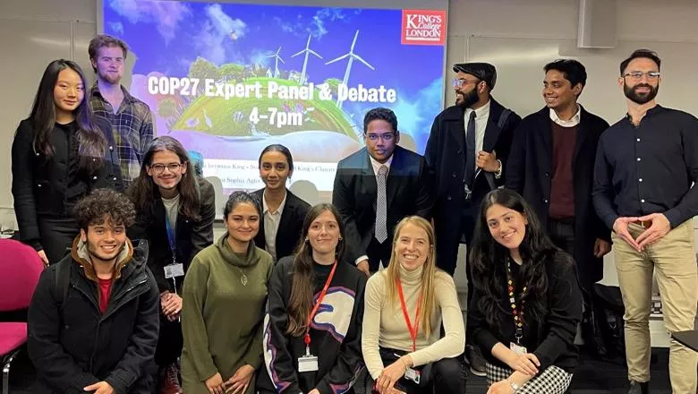 Group picture of 13 students and staff who participated in the COP27 debate.