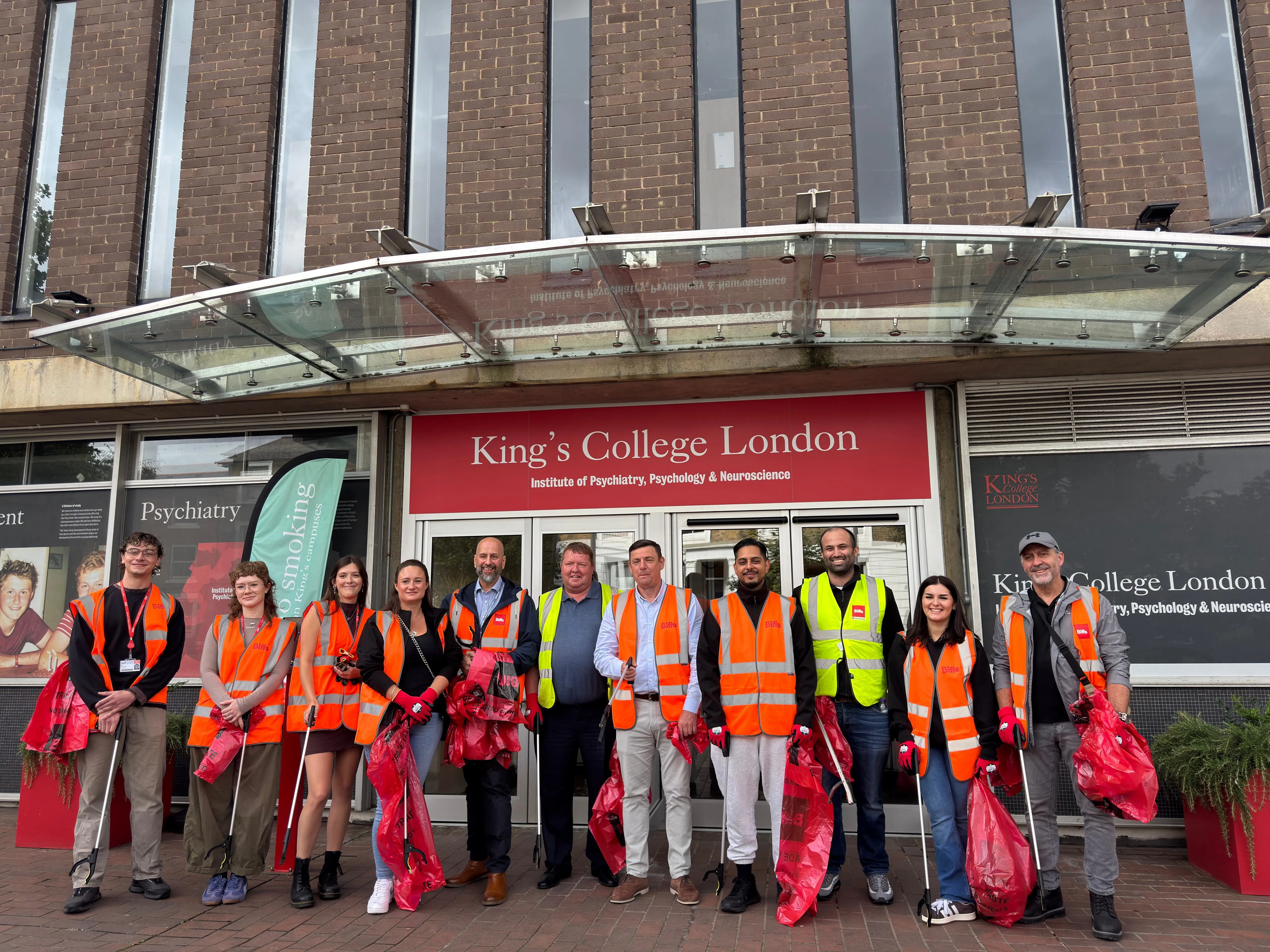 Staff in high vis jackets litter picking at Denmark Hill