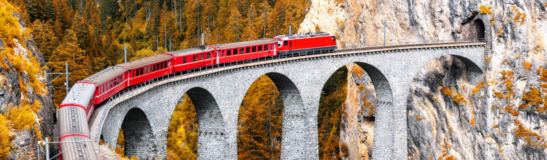 Train on a bridge in autumnal mountains